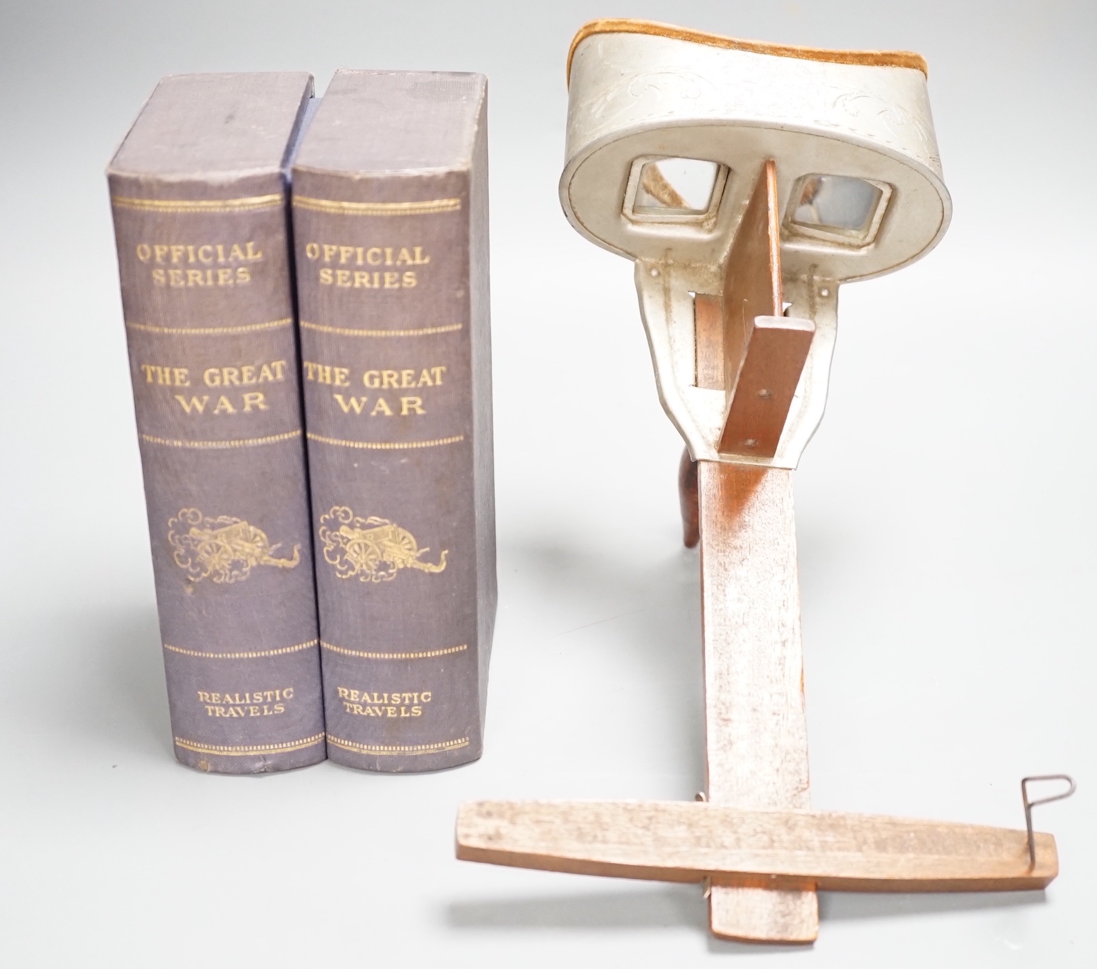 An early 20th century Underwood & Underwood stereoscopic viewer and a set of Great War monochrome cards in faux book binding.